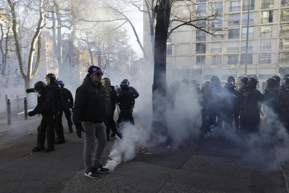 French police take positions during a yellow vest protest in Marseille, southern France, Saturday, Jan. 12, 2019. Paris brought in armored vehicles and the central French city of Bourges shuttered shops to brace for new yellow vest protests. The movement is seeking new arenas and new momentum for its weekly demonstrations. Authorities deployed 80,000 security forces nationwide for a ninth straight weekend of anti-government protests. (AP Photo/Claude Paris)