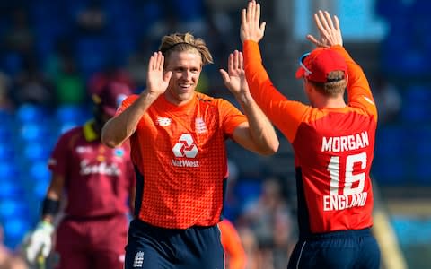 Eoin Morgan congratulates four-wicket Willey - Credit: AFP/Getty Images