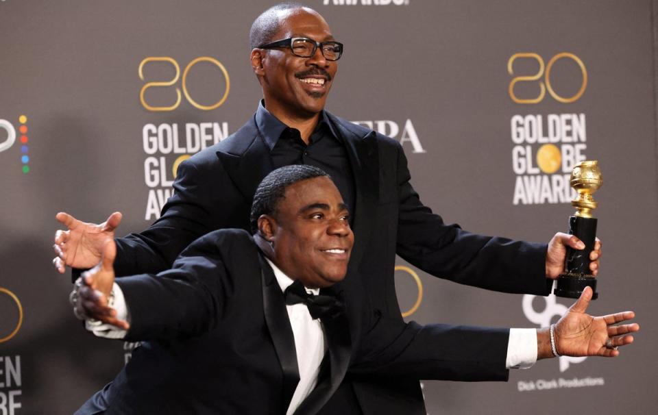 Eddie Murphy poses next to Tracy Morgan with the Cecil B. DeMille Award (REUTERS)