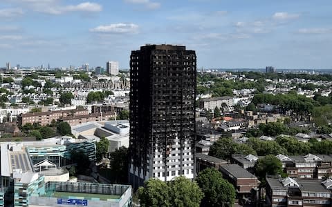 Extensive damage is seen to the Grenfell Tower block  - Credit:  Hannah Mckay/Reuters