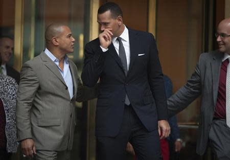 New York Yankees baseball player Alex Rodriguez (C) speaks to Fernando Mateo (L), president of Hispanics Across America, outside the Major League Baseball's (MLB) headquarters in New York October 4, 2013. REUTERS/Carlo Allegri