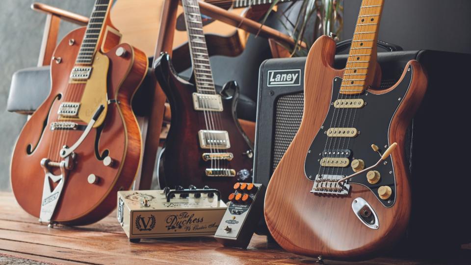 A selection of electric guitars, guitar amps, and pedals