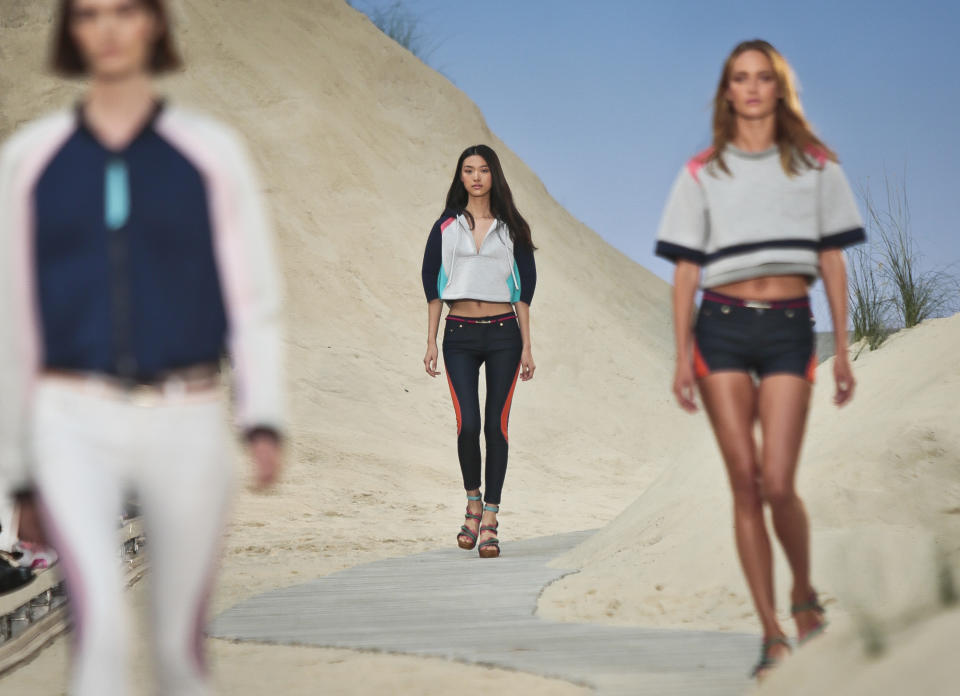 Fashion from the Tommy Hilfiger Spring 2014 collection is modeled on Monday, Sept. 9, 2013 in New York. (AP Photo/Bebeto Matthews)