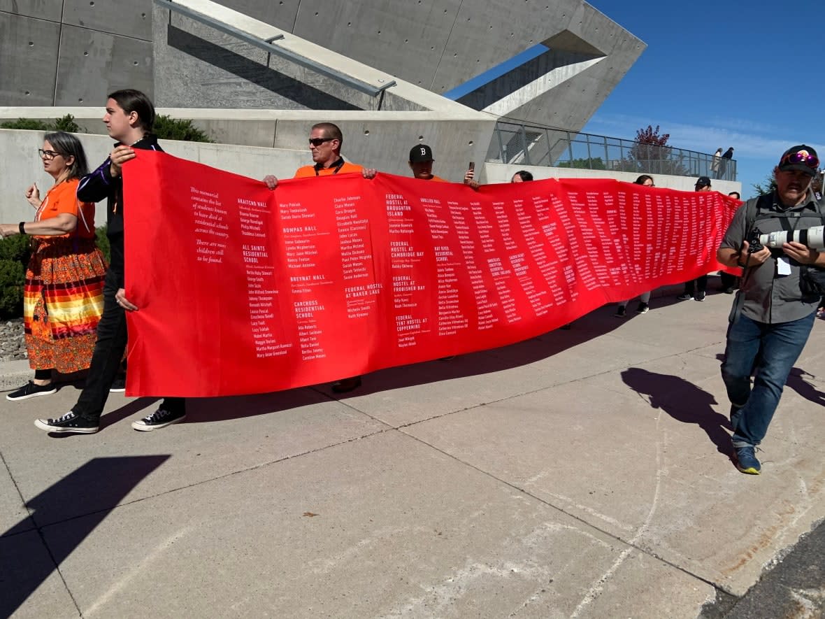 A memorial cloth bearing the names of 4,100 children who did not return from residential schools is carried during a spirit walk on the National Day for Truth and Reconciliation. (Pierre-Paul Couture/CBC - image credit)