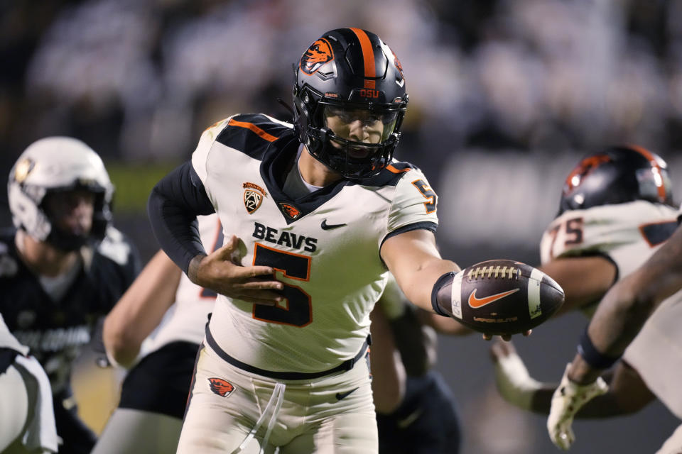 Oregon State quarterback DJ Uiagalelei hands the ball off during the second half of the team's NCAA college football game against Colorado on Saturday, Nov. 4, 2023, in Boulder, Colo. (AP Photo/David Zalubowski)