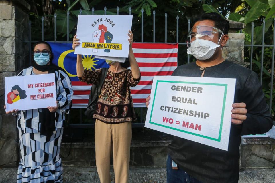 Members of Family Frontiers hold up placards demanding equal citizenship rights for Malaysians outside the Parliament building in Kuala Lumpur September 23, 2021. — Picture by Yusof Mat Isa