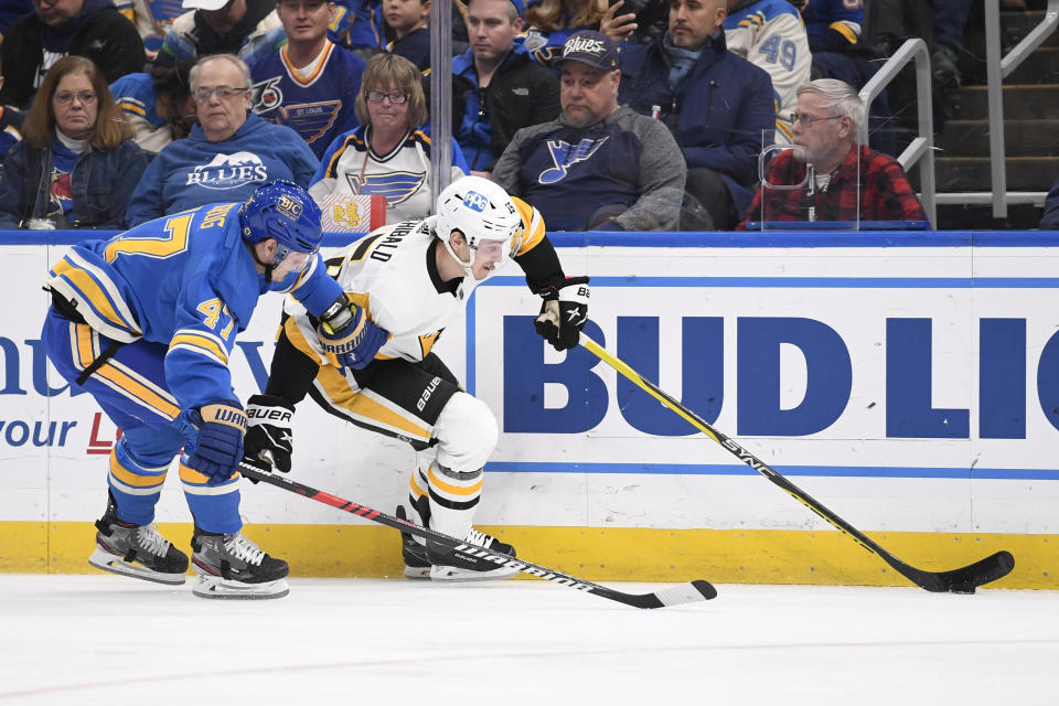 St. Louis Blues defenseman Torey Krug (47) pressures Pittsburgh Penguins right wing Josh Archibald (15) during the first period of an NHL hockey game, Saturday, Feb. 25, 2023, in St. Louis. (AP Photo/Jeff Le)