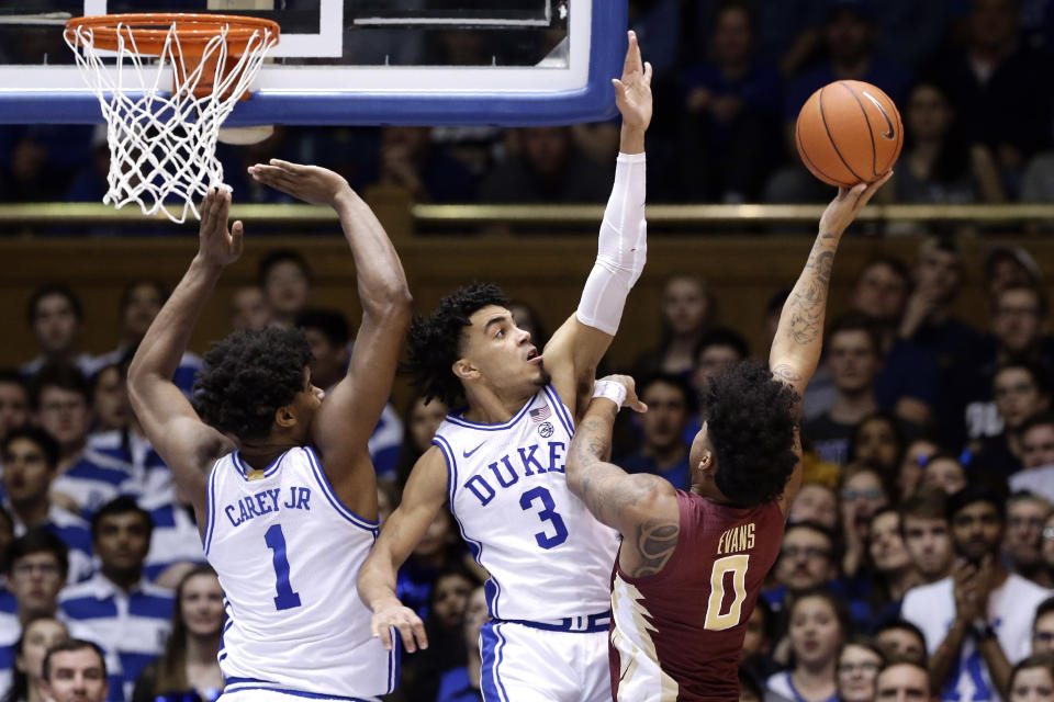 Duke center Vernon Carey Jr. (1) and guard Tre Jones (3) defend against Florida State guard Rayquan Evans (0) during the second half of an NCAA college basketball game in Durham, N.C., Monday, Feb. 10, 2020. (AP Photo/Gerry Broome)