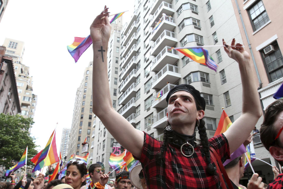 Participants wave flags as they take part in the LGBTQ Pride march, Sunday, June 30, 2019, in New York. (AP Photo/Tina Fineberg)