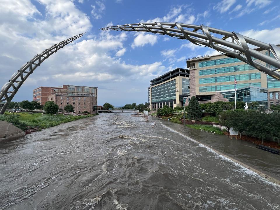 The Big Sioux River is seen rushing Friday, June 21, 2024, through downtown Sioux Falls at high levels after torrential rain overnight.