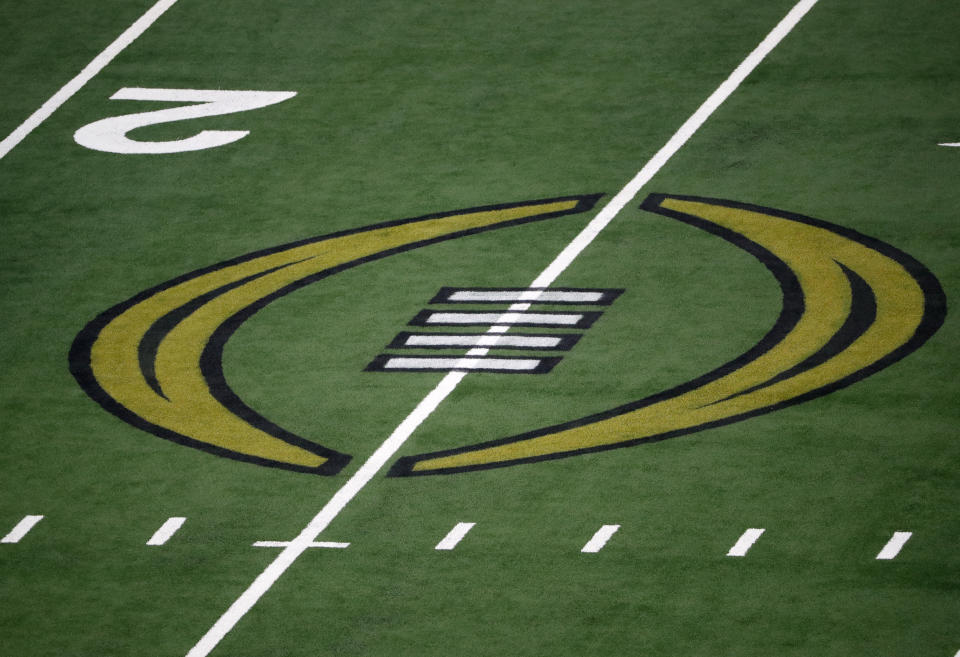 The College Football Championship Playoff logo is shown on the field at AT&T Stadium during the NCAA Cotton Bowl semi-final playoff football game between Clemson and Notre Dame on Saturday, Dec. 29, 2018, in Arlington, Texas. (AP Photo/Roger Steinman)