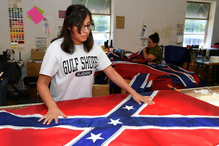 Cynthia Hernandez places stars on a Confederate Battle Flag in the Alabama Flag & Banner shop in Huntsville, Alabama, U.S., August 24, 2017. REUTERS/Harrison McClary