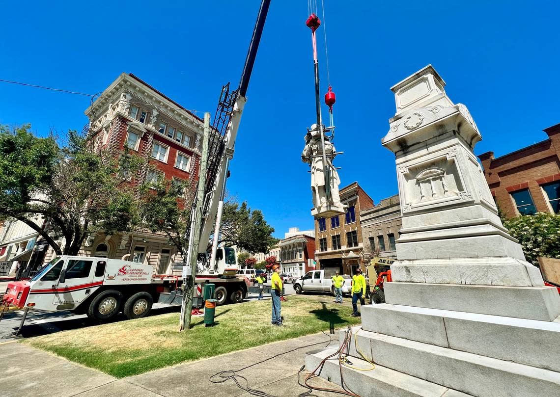 Crews lower the Confederate monument on Cotton Avenue while removing it in this Telegraph file photo. The monument was relocated to Whittle Park in from of Rose Hill Cemetery. The Cotton Avenue space is now expected to be developed as a pedestrian plaza.