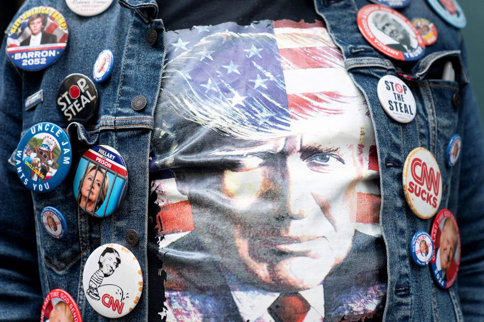 A supporter of former president Donald Trump wears buttons and a shirt with a picture of Trump near Trump Tower in New York on April 3, 2023.<span class="copyright">Stefani Reynolds—AFP/Getty Images</span>