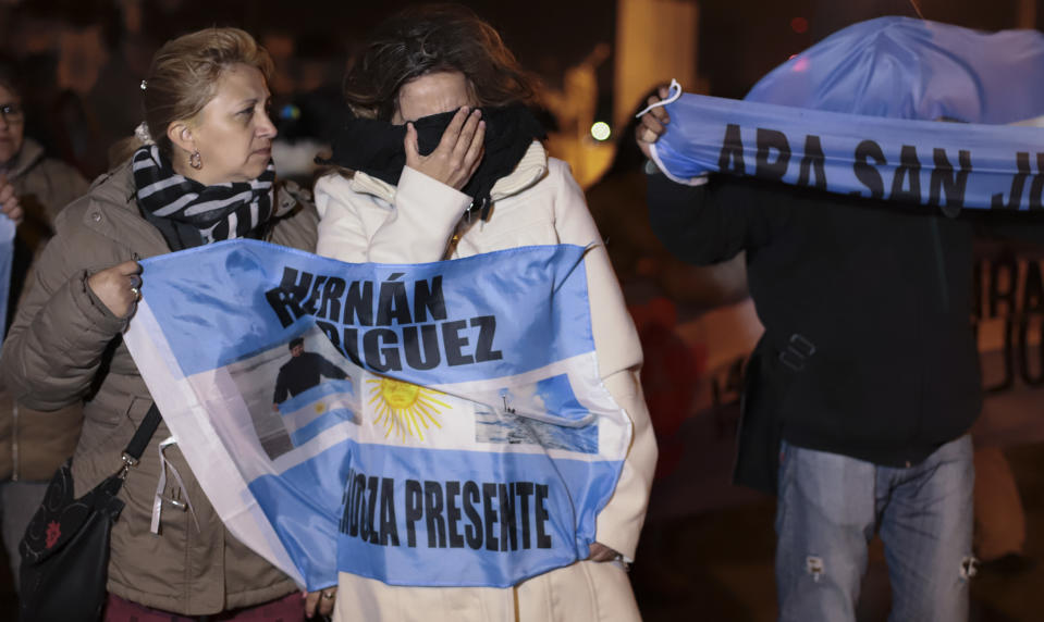 Relatives of the crew of the ARA San Juan submarine embrace outside the navy base in Mar del Plata, Argentina, Saturday, Nov. 17, 2018. Argentina's navy announced early Saturday, that they have located the missing submarine ARA San Juan in the Atlantic a year after it disappeared with 44 crew members aboard.(AP Photo/Federico Cosso)