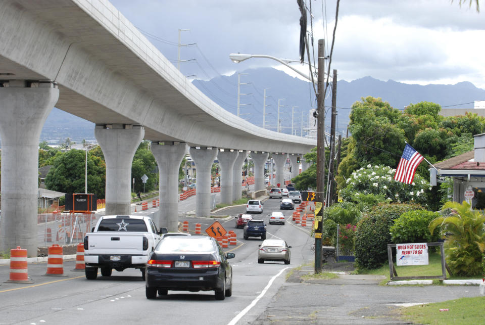 FILE - In this May 18, 2017, file photo, a rail line under construction winds through the Honolulu suburb of Aiea, Hawaii. Honolulu is building one of the nation's most expensive rail lines to address some of the nation's worst traffic but tax revenue declines during the pandemic and spiraling costs mean it doesn't currently have enough money to finish the 20-mile route as planned. (AP Photo/Cathy Bussewitz, File)