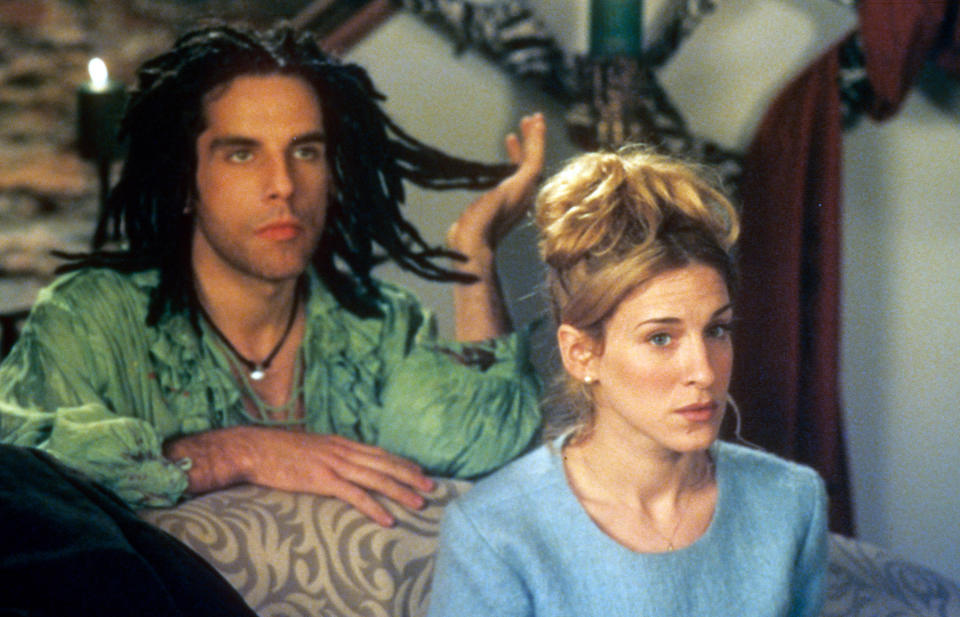 Ben Stiller kneeling behind Sarah Jessica Parker as he pulls at some of the dreadlocks on his head in a scene from the film 'If Lucy Fell'