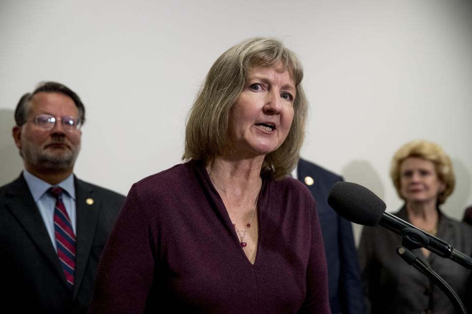 Elizabeth Whelan, the sister of Paul Whelan, accompanied by Sen. Gary Peters., D-Mich., left, and Sen, Debbie Stabenow, D-Mich., right, speaks at a news conference on Capitol Hill in Washington, Thursday, Sept. 12, 2019, to call on Congress to pass a resolution condemning the Russian government for detaining Paul Whelan. (AP Photo/Andrew Harnik)