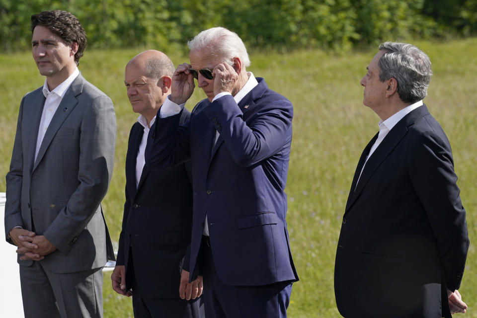 President Joe Biden, third from left, puts on his sunglasses as he stands with, from left, Canadian Prime Minister Justin Trudeau, German Chancellor Olaf Scholz, and Prime Minister of Italy Mario Draghi, during an event to formally launch the global infrastructure partnership, on the margins of the G7 Summit in Elmau, Germany, Sunday, June 26, 2022. (AP Photo/Susan Walsh)