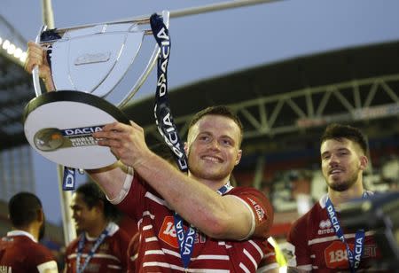 Britain Rugby League - Wigan Warriors v Cronulla-Sutherland Sharks - World Club Challenge - DW Stadium - 19/2/17 Joe Burgess of Wigan Warriors celebrates with the trophy after the game Mandatory Credit: Action Images / Ed Sykes Livepic