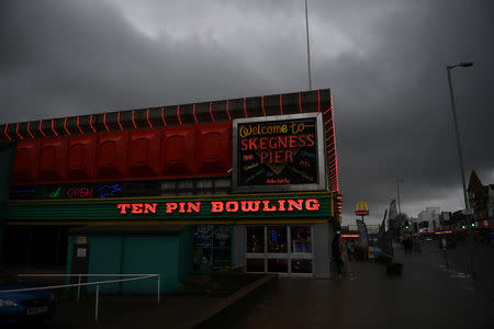 A ten pin bowling sign is illuminated on the side of an amusement arcade in Skegness, Britain March 3, 2019. REUTERS/Clodagh Kilcoyne/Files