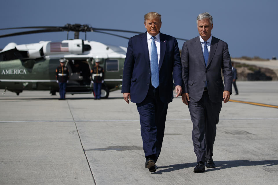 President Donald Trump and new National security adviser Robert O'Brien walk to talk with reporters before boarding Air Force One at Los Angeles International Airport, Wednesday, Sept. 18, 2019, in Los Angeles. (AP Photo/Evan Vucci)