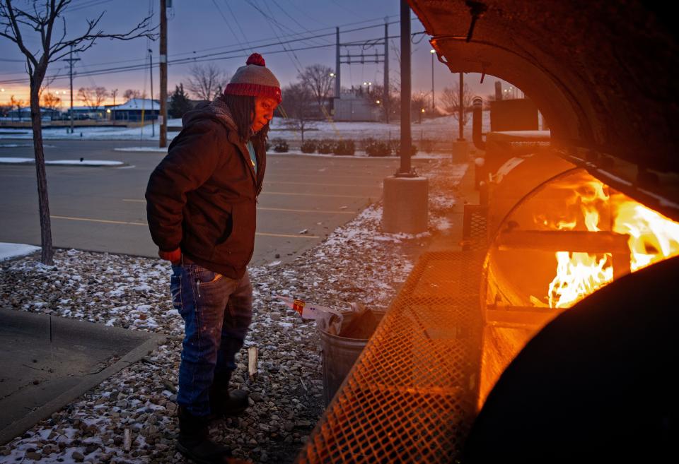 Willie Ray Fairley, the owner of Willie RayÕs ÒQÓ Shack, lights the grills as the sun rises over Cedar Rapids, Thursday, Nov. 17, 2022.