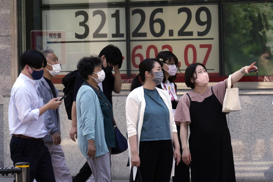 People stand in front of an electronic stock board showing Japan's Nikkei 225 index at a securities firm Monday, June 5, 2023, in Tokyo. Asian stocks followed Wall Street higher on Monday after strong U.S. hiring data coupled with scant wage gains suggested a possible recession might be further away, but also that inflationary pressures are weakening. (AP Photo/Eugene Hoshiko)