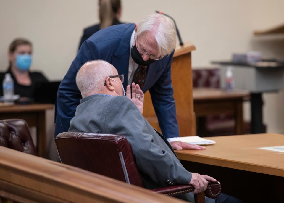 Former Gulf Breeze Mayor Ed Gray, bottom, talks with his attorney after being sentenced to prison at the Santa Rosa County Court House in Milton on Tuesday, August 24, 2021.  Gray pleaded no contest to eight counts of video voyeurism, one count of illegal interception of communications, one count of illegally installing a tracking device and one count of stalking.