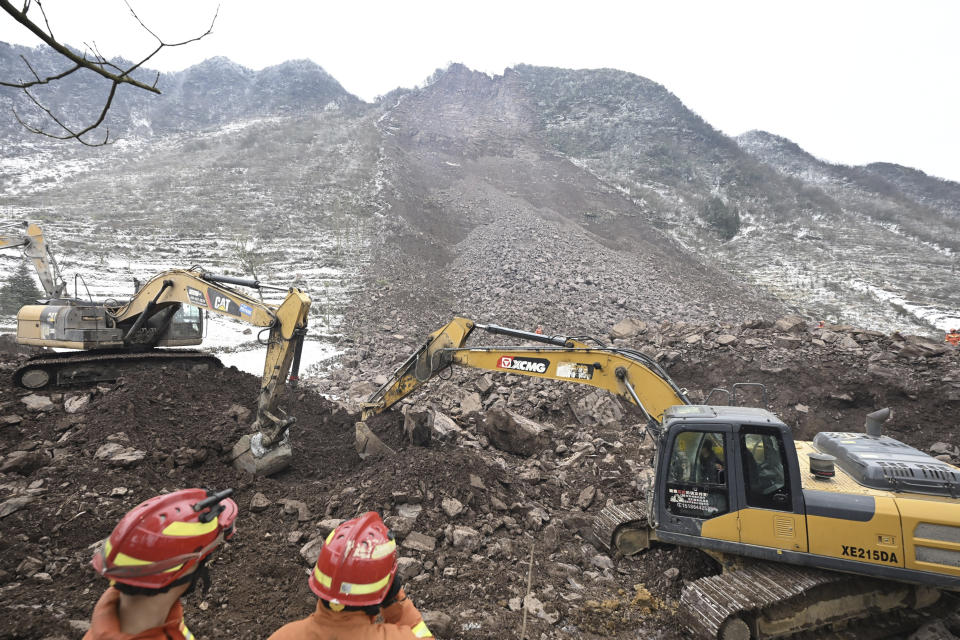In this photo released by Xinhua News Agency, rescue workers look on as excavators dig at the site of a landslide in Liangshui village, Tangfang Town in the city of Zhaotong in southwestern China's Yunnan Province, Monday Jan. 22, 2024. The landslide in southwestern China's mountainous Yunnan province early Monday buried dozens and forced the evacuation of hundreds (Yue Yuewei/Xinhua via AP)