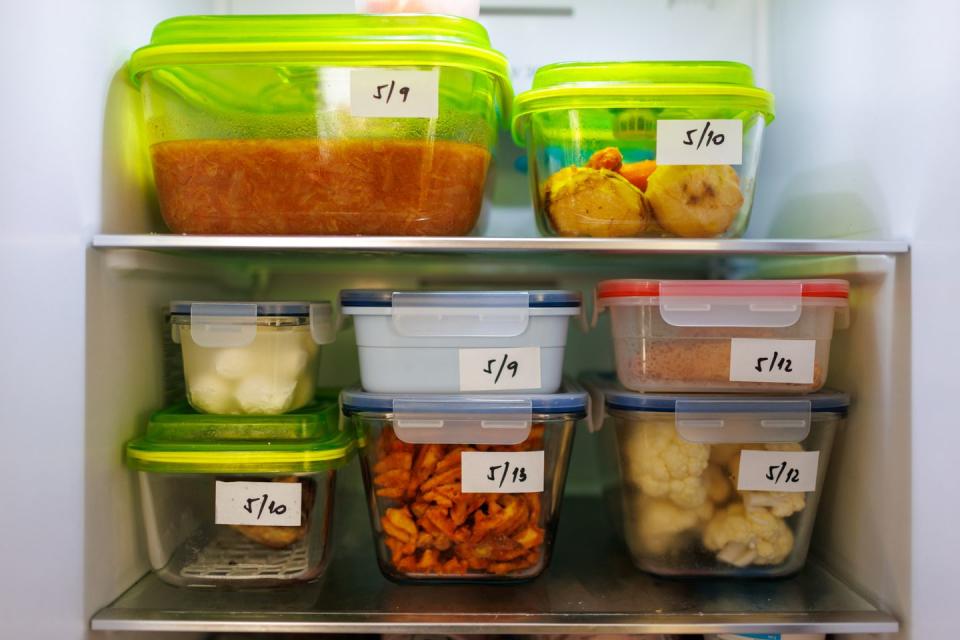 food leftovers packaged in boxes inside a home fridge