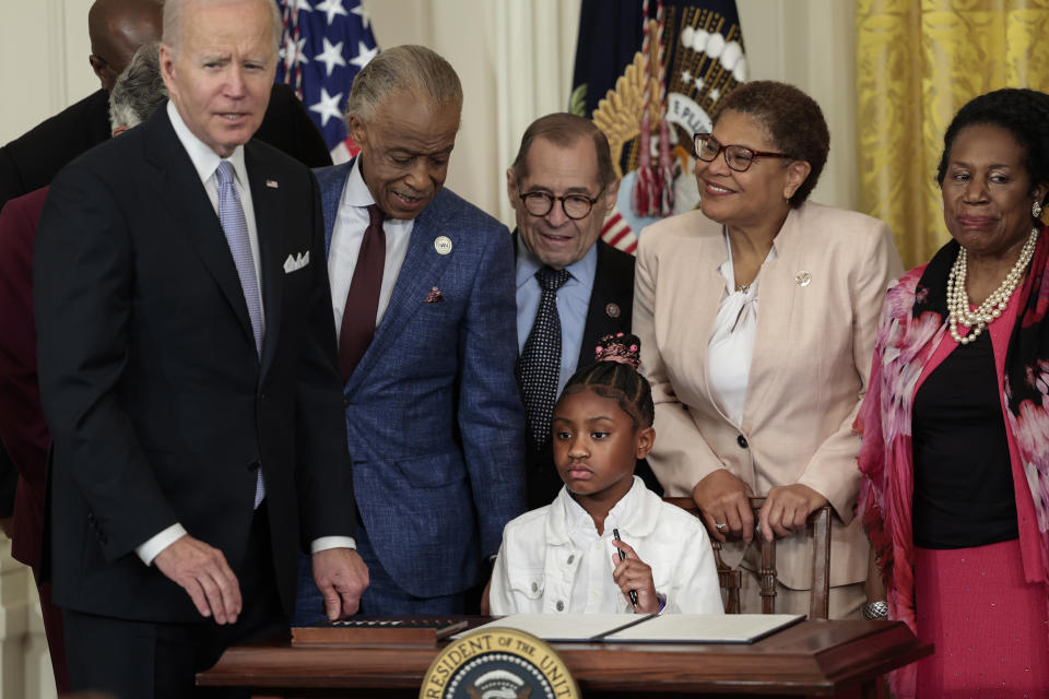 Gianna Floyd, the daughter of George Floyd, holds a pen used by U.S. President Joe Biden to sign an executive order enacting further police reform in the East Room of the White House on May 25, 2022 in Washington, DC. President Biden’s executive order is intended to improve police accountability and direct federal agencies to revise use-of-force policies, like banning tactics such as the chokehold. - Credit: Anna Moneymaker/Getty Images