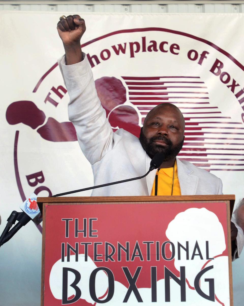 Mark "Too Sharp" Johnson pumps his fist after accepting his induction into the International Boxing Hall of Fame during the induction ceremony in Canastota, N.Y., Sunday, June 10, 2012. (AP Photo/Heather Ainsworth)