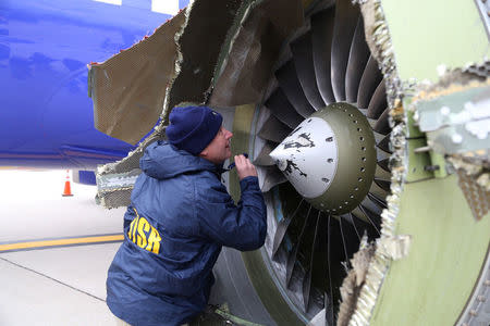 A U.S. NTSB investigator is on scene examining damage to the engine of the Southwest Airlines plane in this image released from Philadelphia, Pennsylvania, U.S., April 17, 2018. NTSB/Handout via REUTERS