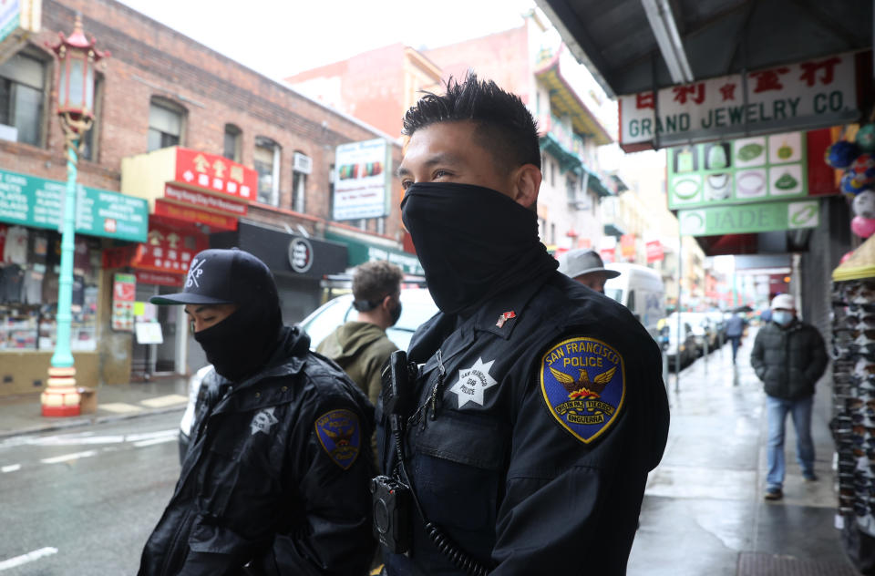 Two police officers walk down Grant Avenue while on foot patrol in Chinatown in San Francisco.