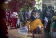 FILE - In this April 15, 2021, file photo, a woman gets her swab sample taken to test for COVID-19 at a government hospital in Noida, a suburb of New Delhi, India. The global death toll from the coronavirus topped a staggering 3 million people Saturday, April 17, 2021, amid repeated setbacks in the worldwide vaccination campaign and a deepening crisis in places such as Brazil, India and France. (AP Photo/Altaf Qadri, File)