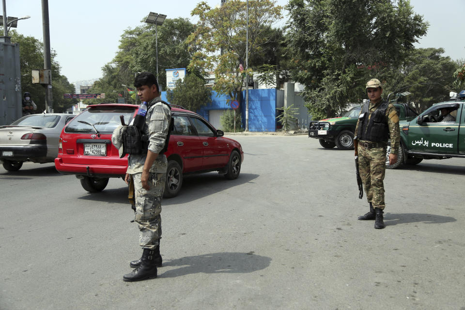 Afghan police stand guard at the site of rocket attack in the city of Kabul, during Independence Day celebrations at Defense Ministry in Kabul, Afghanistan, Tuesday, Aug. 18, 2020, Several mortar shells slammed into various part of Kabul on Tuesday morning as Afghans marked their country's Independence Day amid new uncertainties over the start of talks between the Taliban and the Kabul government. (AP Photo/Mariam Zuhaib)