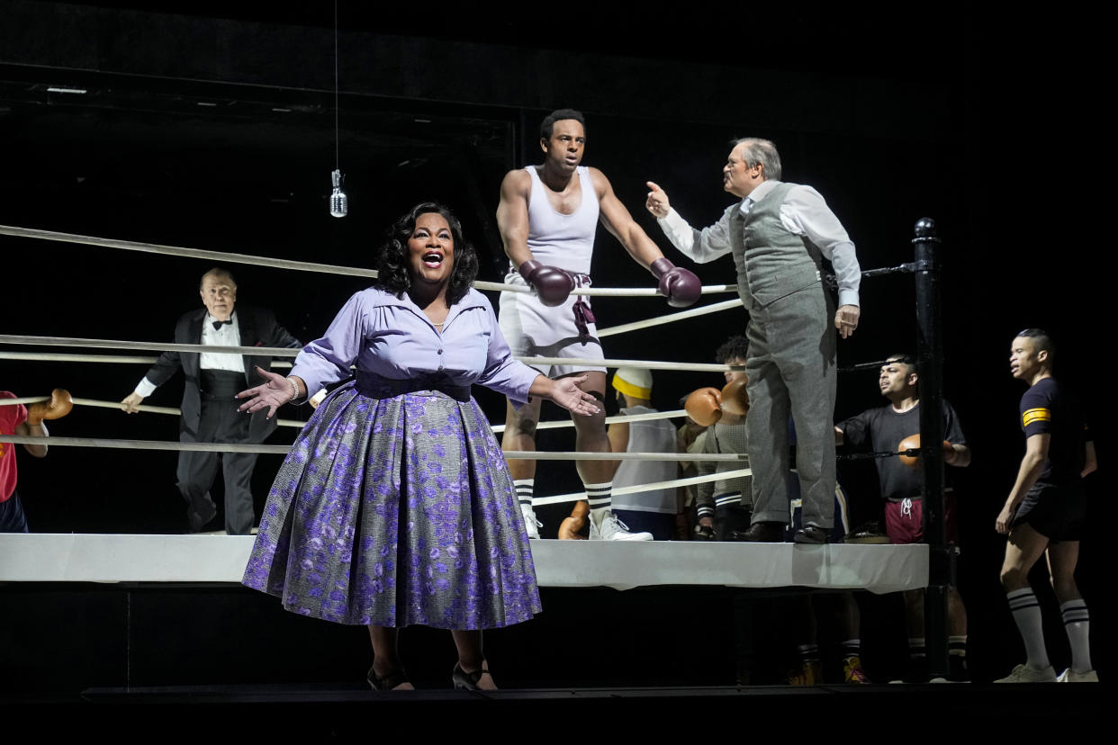 Lee Wilkof, left, as the ring announcer, Latonia Moore as Emelda Griffith, Ryan Speedo Green as young Emile Griffith, and Paul Groves as Howie Albert in Terence Blanchard's 