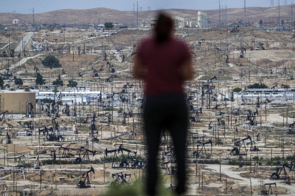 A person looks over the immense Chevron Kern River Oil Field from Panorama Drive.