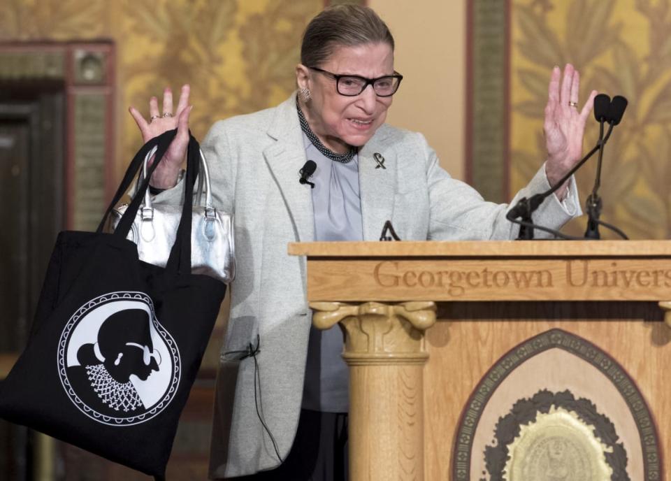 <div class="inline-image__caption"><p>Supreme Court Justice Ruth Bader Ginsburg acknowledges applause as she arrives to speak at Georgetown University in Washington, DC, on April 27, 2017. In later years, thanks to her fiery dissents and recognizable style, “Notorious RBG” became a pop-culture icon (as seen on her meta tote).</p></div> <div class="inline-image__credit">SAUL LOEB/Getty</div>