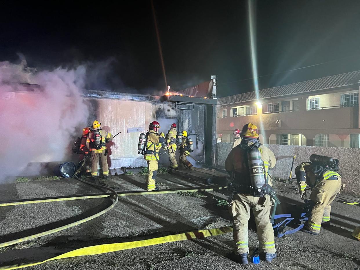 Firefighters battle an early morning blaze on Saturday in Hesperia. The fire tore through an abandoned commercial building once used as a gentlemen's club bikini bar.