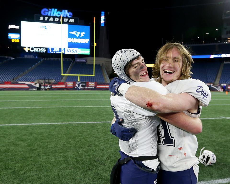 Rockland’s Gavin Wardwell and Jacob Coulstring embrace following their 23-13 win over Abington in the Division 6 state title game at Gillette Stadium on Friday, Dec. 3, 2021.