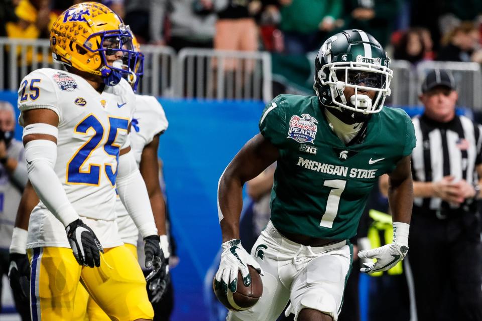 Michigan State wide receiver Jayden Reed (1) scores a touchdown against Pittsburgh defensive back A.J. Woods (25) during the first half of the Peach Bowl at the Mercedes-Benz Stadium in Atlanta, Ga. on Thursday, Dec. 30, 2021.