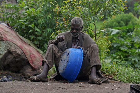 Kavuha, 73, repairs a container at Kagorwa Pygmy camp on Idjwi island in the Democratic Republic of Congo, November 22, 2016. REUTERS/Therese Di Campo