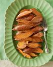 <p>Here roasted sweet potatoes are slathered with a spiced and sugared butter. Delicious as a side dish or as a simple appetizer, this easy recipe is sure to satisfy. </p><p><strong><a href="https://www.countryliving.com/food-drinks/recipes/a3585/spiced-sweet-potatoes-recipe-clx0411/" rel="nofollow noopener" target="_blank" data-ylk="slk:Get the recipe for Spiced Sweet Potatoes;elm:context_link;itc:0;sec:content-canvas" class="link ">Get the recipe for Spiced Sweet Potatoes</a>.</strong></p>