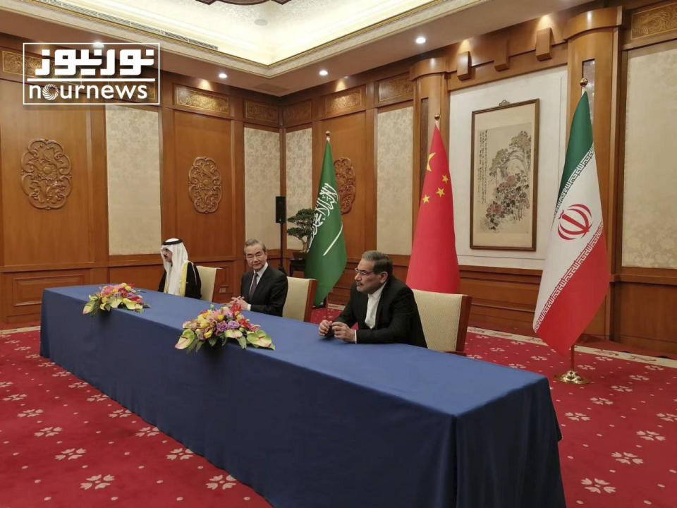 In this photo released by Nournews, Secretary of Iran's Supreme National Security Council, Ali Shamkhani, right, China's most senior diplomat Wang Yi, center, and Saudi Arabia's National Security Adviser Musaad bin Mohammed al-Aiban looks on during an agreement signing ceremony between Iran and Saudi Arabia to reestablish diplomatic relations and reopen embassies after seven years of tensions between the Mideast rivals, in Beijing, China, Friday, March 10, 2023. (Nournews via AP)