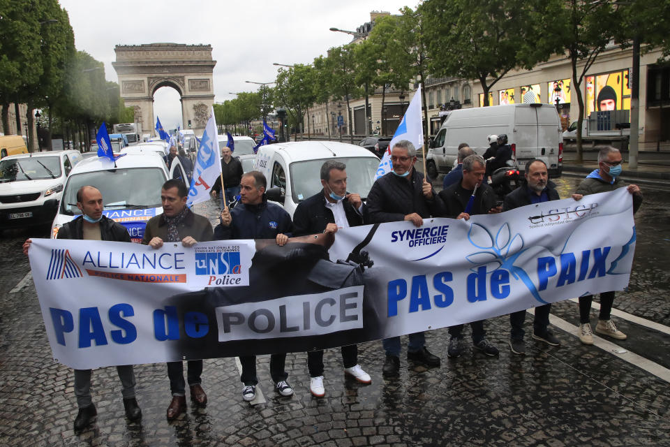 French police unionists demonstrate with a banner reading"No police, no peace" on the Champs-Elysee avenue near the Arc de Triomphe, Friday, June 12, 2020 in Paris. French police are protesting a new ban on chokeholds and limits to what they can do during arrests, part of government efforts to stem police brutality and racism in the wake of global protests over George Floyd's death in the U.S. (AP Photo/Michel Euler)