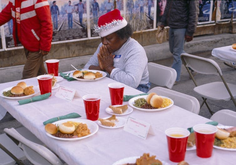 <span class="caption">A woman gives thanks for her Christmas dinner.</span> <span class="attribution"><span class="source">Joseph Sohm / Shutterstock.com</span></span>