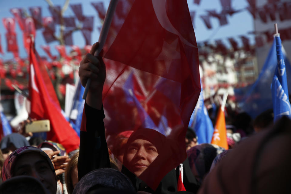 FILE-In this Tuesday, March 5, 2019 file photo, supporters of Turkey's President Recep Tayyip Erdogan's ruling Justice and Development Party (AKP) wave flags during a rally in Istanbul, ahead of local elections scheduled for March 31, 2019. As with previous elections, Erdogan has been holding multiple daily rallies across the country, using highly polarising language, portraying the opposition as traitors who are supported by terrorists, blaming ills on foreign forces and stirring up nationalist and religious sentiments. (AP Photo/Lefteris Pitarakis, File)