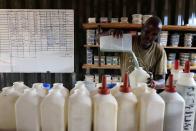 A keeper prepares bottles of milk before feeding orphaned elephants, at the Reteti elephant sanctuary in Samburu county